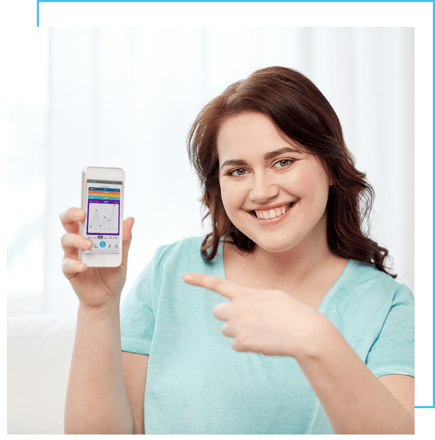 Woman smiling while holding a smartphone displaying an app.